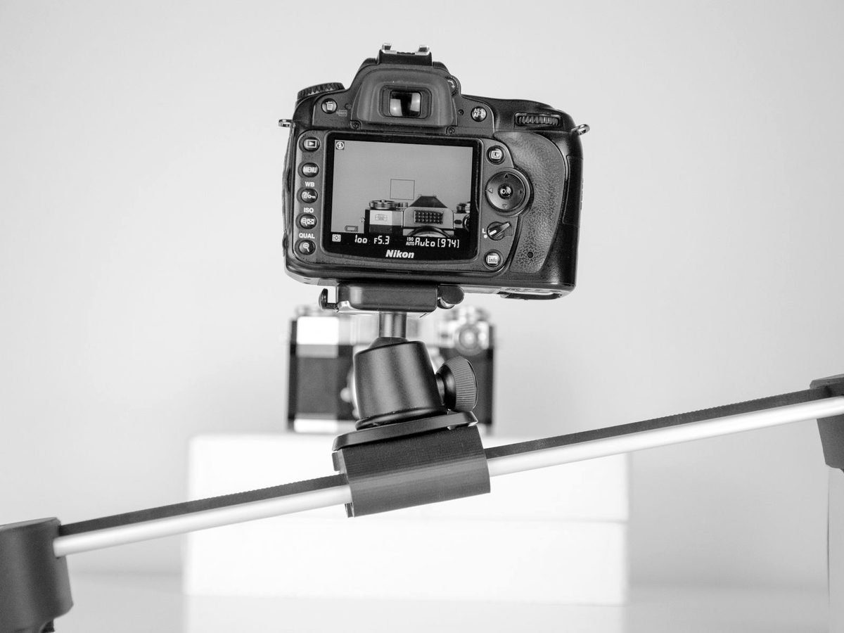 A camera on a rig photographing a product against a white background